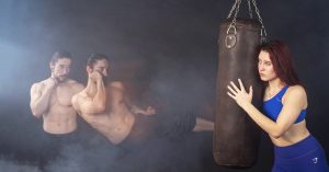 A woman in a blue sports bra holds a punching bag, while a shirtless man is shown in multiple action poses, punching and kicking toward the bag in a smoky gym setting.