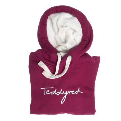 Professional Product Photography of a beautifully folded maroon hoodie